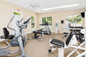 a fitness room with treadmills and cardio equipment at Bright Coastal Condo in Saint Simons Island