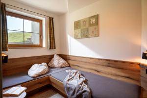 a bed in a room with a window at Appartements Sonntal Einkehr in Fieberbrunn +60 photos