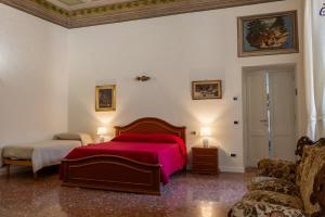 a bedroom with a bed with a red blanket at B&B del pozzo in Narni