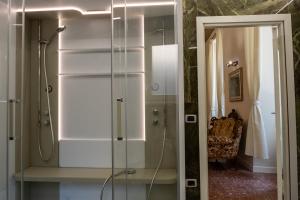 a shower with a glass door in a bathroom at B&B del pozzo in Narni