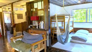 a room with a hammock and a bed in it at 暮らす宿ソラプチ Sorapchi Cabin in Ochiai