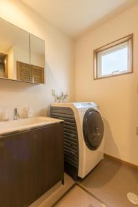 a kitchen with a sink and a dryer in a room at Kiseki in Kutchan +25 photos