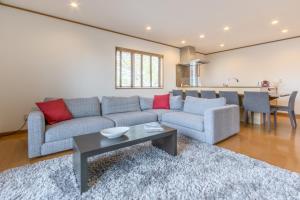 a living room with a couch and a table at Kiseki in Kutchan