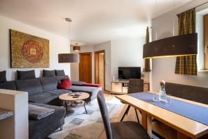 a living room with a couch and a table at Appartements Sonntal Einkehr in Fieberbrunn