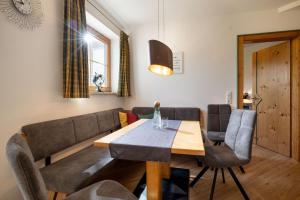 a living room with a table and a couch at Appartements Sonntal Einkehr in Fieberbrunn