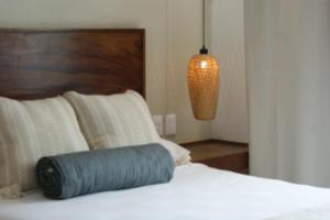 a blue pillow sitting on a bed in a room at Hotel Boutique Kasa Sara in San Patricio Melaque +1 photo