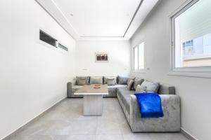 a living room with a couch and a table at Reda Appartements Al Hoceima in Al Hoceïma