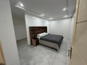 a bedroom with a bed in a white room at Reda Appartements Al Hoceima in Al Hoceïma +41 photos