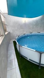 a large bath tub in a room with grass at Reda Appartements Al Hoceima in Al Hoceïma