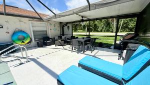 a covered patio with a table and a volley ball at Relaxing place with pool in Cape Coral