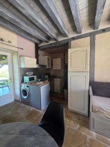 a kitchen with a washer and dryer in a room at Gîte L' authentique in Saint-Germain-des-Bois +4 photos