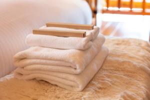 a pile of towels sitting on top of a bed at Villa Rusutsu in Rusutsu