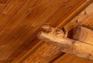 a wooden carving of a cat hanging from a ceiling at Villa Rusutsu in Rusutsu