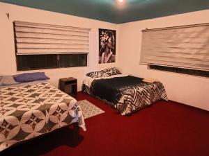 a bedroom with a bed and a window at Hare Maohi in Hanga Roa