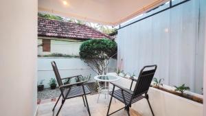 a patio with two chairs and a table on a balcony at Avanthi Homestay in Varkala