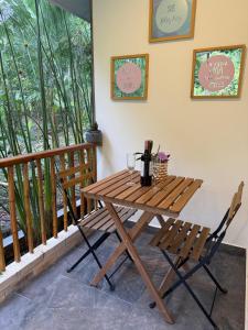 a wooden table and two chairs on a balcony at Morada Silvestre in La Peña