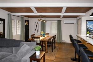 a living room with a couch and a table with chairs at Tall Timber in Packwood