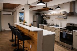a kitchen with a large island with bar stools at Tall Timber in Packwood