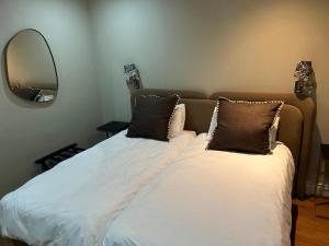 two beds in a room with a mirror at Cape Royale Luxury Suite 602 in Cape Town