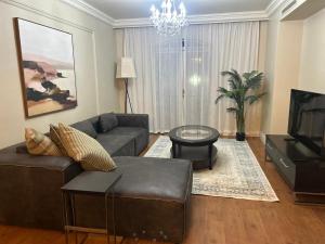 a living room with a couch and a tv at Cape Royale Luxury Suite 602 in Cape Town