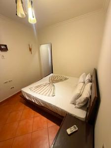 a bed in a room with a remote control on it at Porto Sokhna Aprtment Pool View - MR in Ain Sokhna
