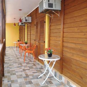 a row of tables and chairs in a restaurant at Pousada dos Pescadores in Bertioga