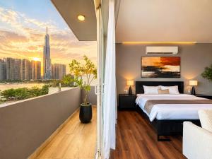 a bedroom with a bed and a view of a city at Amana Boutique Riverside - An Khanh in Ho Chi Minh City +90 photos