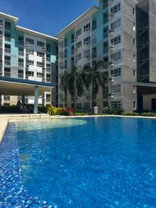 a large swimming pool in front of some buildings at Davao Cozy Condo T6 unit 2 in Davao City