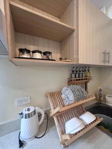 a kitchen with wooden cabinets and a sink at Davao Cozy Condo T6 unit 2 in Davao City