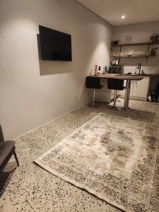 a living room with a table and a rug on the floor at Windsor Cottage in Avondale