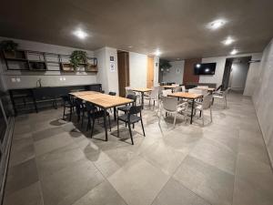 a restaurant with tables and chairs in a room at The Hilltop Apartment in Guadalajara