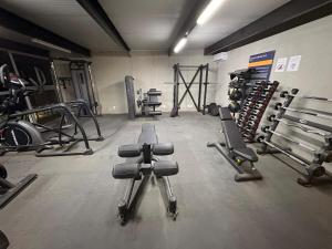 a gym with several weight machines in a room at The Hilltop Apartment in Guadalajara