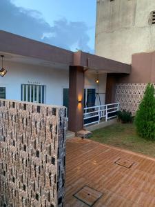 a house with a stone wall and a fence at Villa de 2 chambres in Porto-Novo