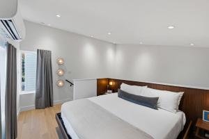 a bedroom with a large white bed and a window at Hotel SOMA in Fort Worth