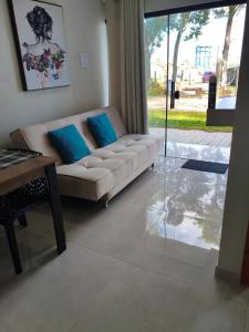 a living room with a couch and a table at Morada dos eucaliptos in Capão da Canoa