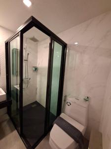 a bathroom with a toilet and a glass shower at The Seens Hotel in Krabi +49 photos
