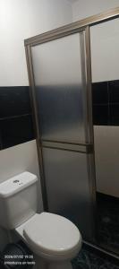 a bathroom with a toilet and a shower at HotelSueñosCafeteros in Montenegro