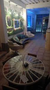 a living room with a glass table and chairs at HotelSueñosCafeteros in Montenegro
