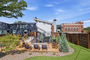 a patio with chairs and a table in a yard at Hotel SOMA in Fort Worth
