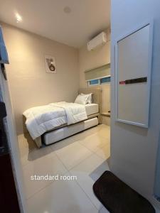 a bedroom with a bed in a room with a door at Gassania Hostel in Banda Aceh +10 photos