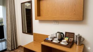 a kitchen with a counter with a coffee maker on it at JHS Kundli in Sonīpat