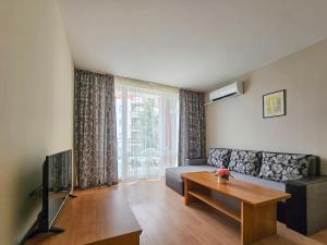 a living room with a couch and a table at Marina and Panorama Apartments in Sveti Vlas