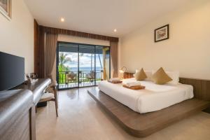 a bedroom with a large white bed and a balcony at Tanote Villa resort, Koh-Tao in Ko Tao