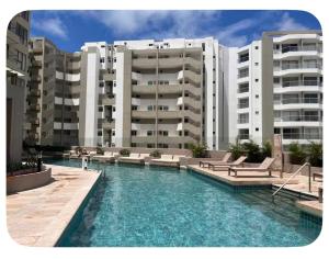 a swimming pool in front of some apartment buildings at Apartamento tipo Loft in Gaira