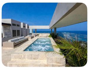 a villa with a swimming pool and a patio at Apartamento tipo Loft in Gaira