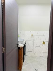 a bathroom with a sink and a white counter top at Hiyadel balcony in Sadgeri +6 photos