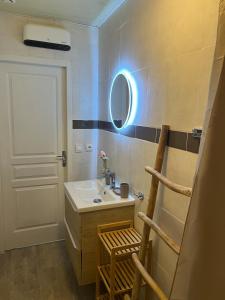 a bathroom with a sink and a mirror at Le Cocon d aurélie in Thèzan-lès-Béziers +10 photos