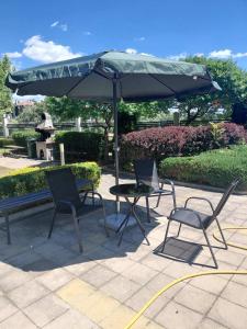 a table and two chairs under an umbrella at Aspen Luxury Apartament in Razlog