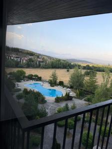 a view of a swimming pool from a balcony at Aspen Luxury Apartament in Razlog