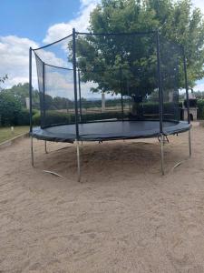 a metal trampoline with a tree in the middle at Aspen Luxury Apartament in Razlog